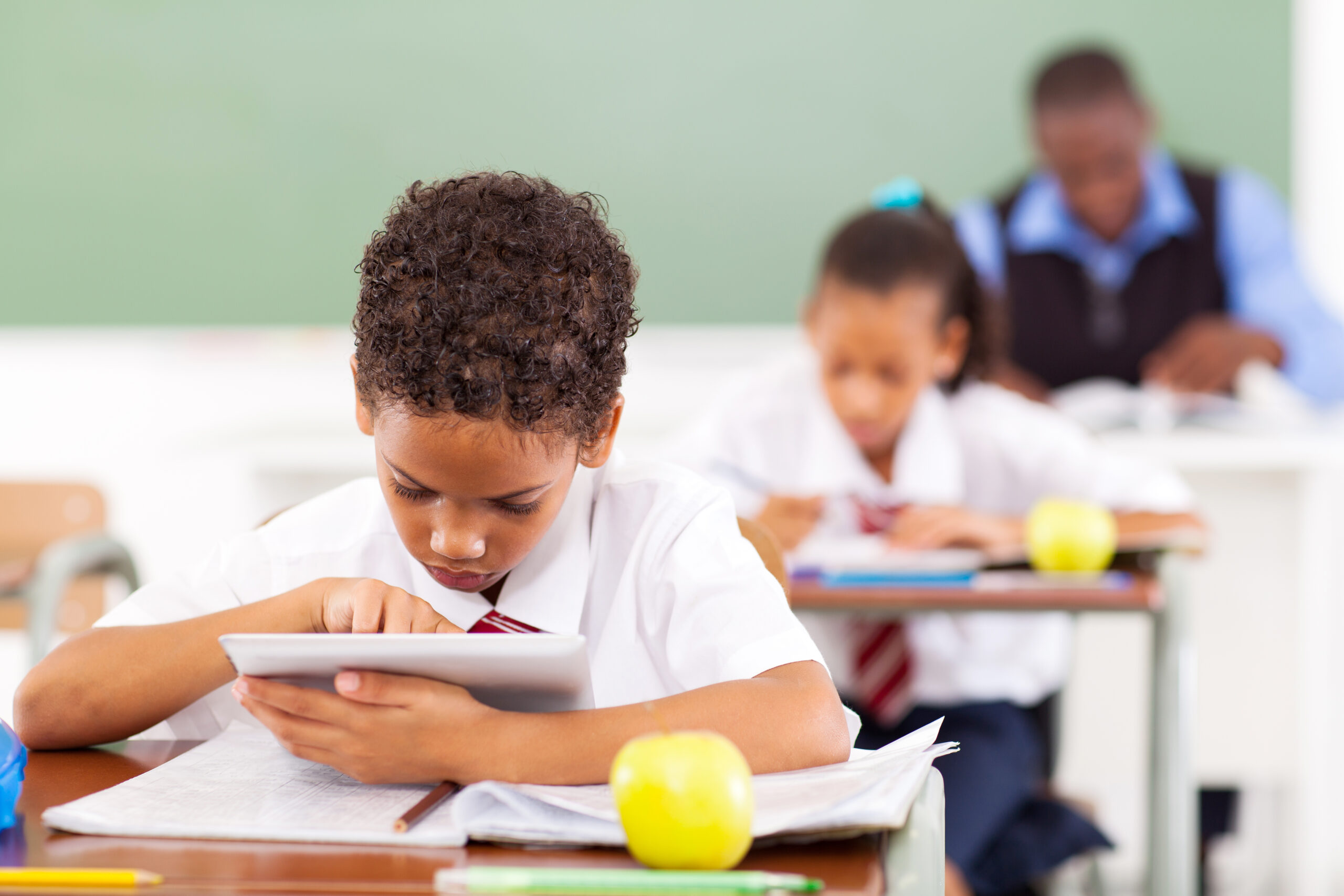 Cute,Elementary,Schoolboy,Using,A,Tablet,Computer,In,Classroom